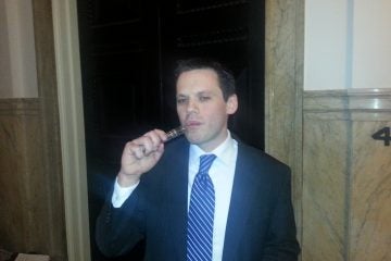  Greg Conley vaporizes with his e-cig after giving testimony in Philadelphia City Hall on Thursday, Mar. 27, 2014 (Tom MacDonald/WHYY) 