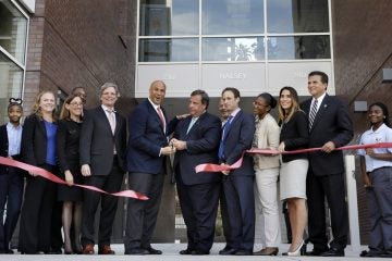  Mayor Cory Booker, center left and Gov. Christie, center right, help celebrate the opening of a new charter school in Newark, N.J. on Sept. 25, 2013. Booker is now in the U.S. Senate.(AP Photo/Mel Evans) 