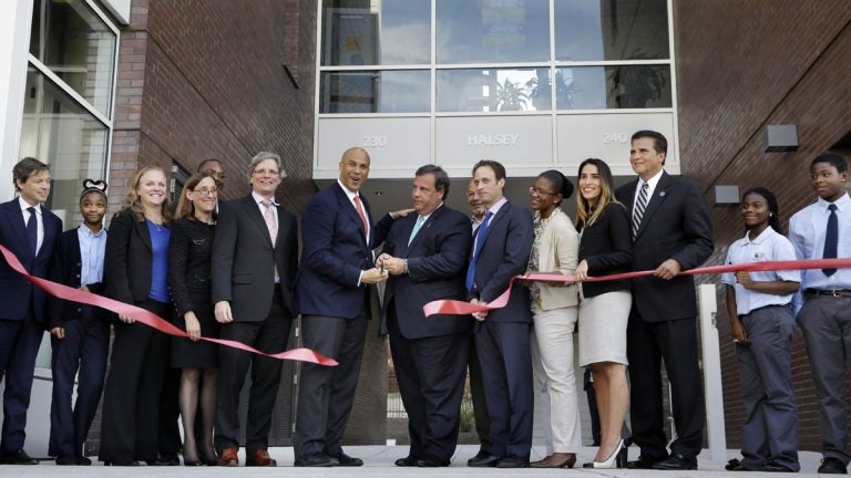  Mayor Cory Booker, center left and Gov. Christie, center right, help celebrate the opening of a new charter school in Newark, N.J. on Sept. 25, 2013. Booker is now in the U.S. Senate.(AP Photo/Mel Evans) 