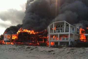  Fire engulfs three homes near the beachfront, Friday, April 18, 2014, in Sea Isle City, N.J.  (AP Photo/Joanne Dollarton) 