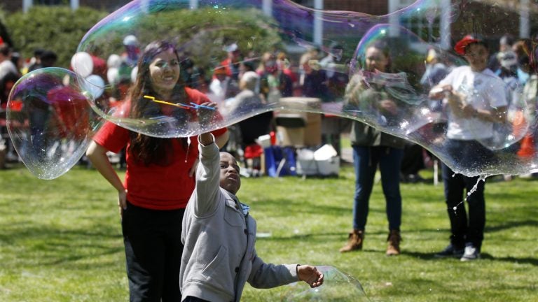  Children play with huge bubbles during the Rutgers Day events in New Brunswick, N.J., Saturday, April 26, 2014.  (AP Photo/Mel Evans) 