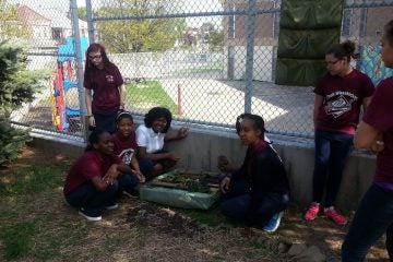  Cook-Wissahickon students displaying a part of their greening efforts. (Queen Muse/for NewsWorks) 
