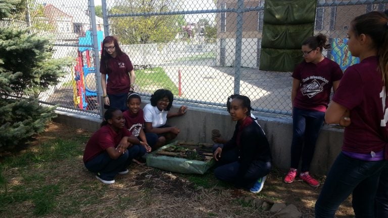  Cook-Wissahickon students displaying a part of their greening efforts. (Queen Muse/for NewsWorks) 