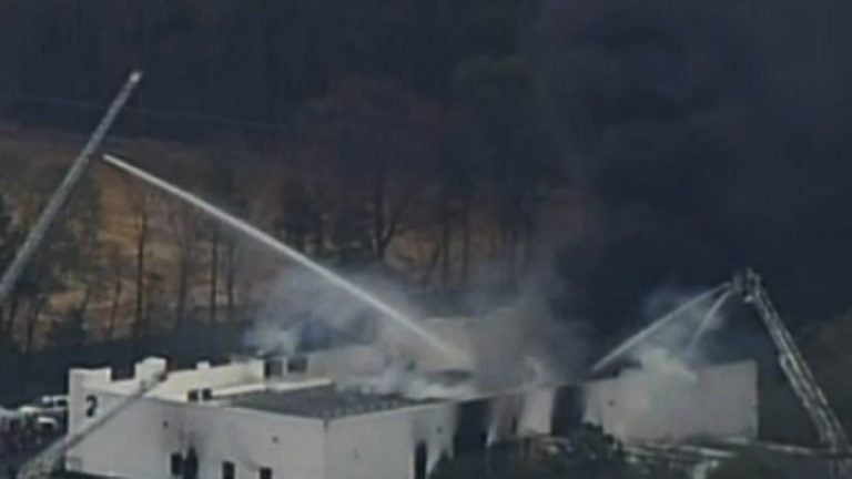  Smoke rising from ResinTech earlier today.  (Image via NBC10) 