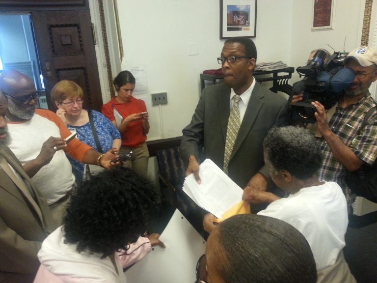  Philadelphia City Council President Darrell Clarke accepts petitions against the sale of the Philadelphia Gas Works. (Tom MacDonald/WHYY) 