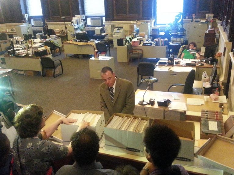  Council Chief Clerk Michael Decker receives petitions calling for a locally elected school board to run the Philadelphia public schools. (Tom MacDonald/WHYY) 