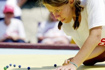  Carly Miller, 12, shoots during the finals of the  National Marbles Tournament in Wildwood in 2004. (AP File Photo/Mary Godleski) 