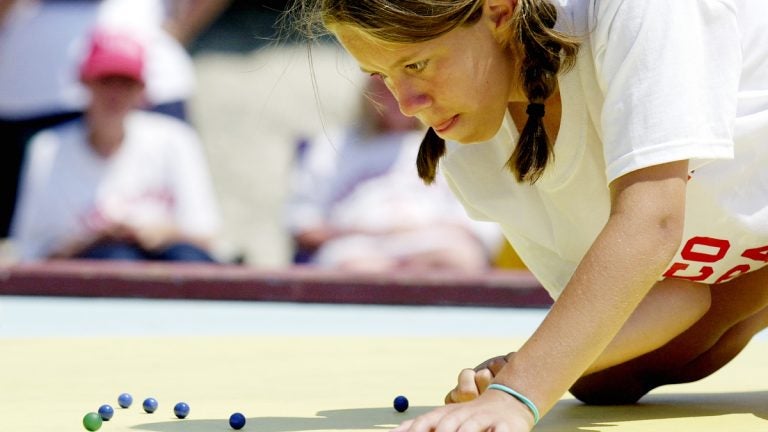  Carly Miller, 12, shoots during the finals of the  National Marbles Tournament in Wildwood in 2004. (AP File Photo/Mary Godleski) 