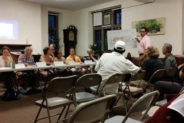  Zoning attorney Bill Curr presents revised building plans to West Mt. Airy Neighbors members and residents at Wednesday's meeting. (Queen Muse/for NewsWorks) 