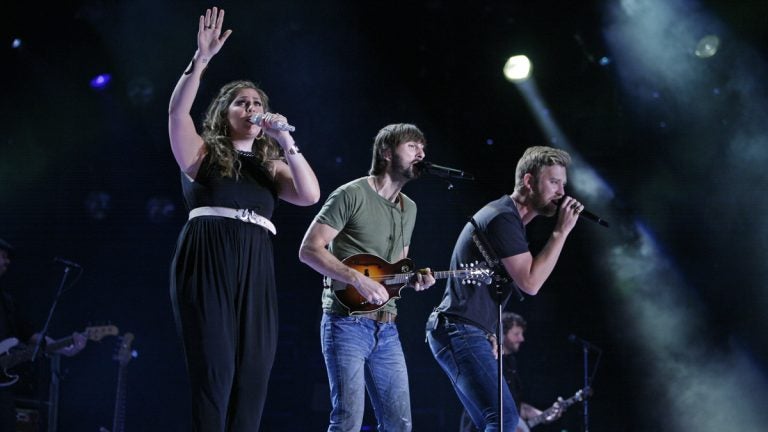  Lady Antebellum members Hillary Scott, left, Charles Kelley, center. and Dave Haywood perform during the CMA Fest in june 2014. (Photo by Wade Payne/Invision/AP) 