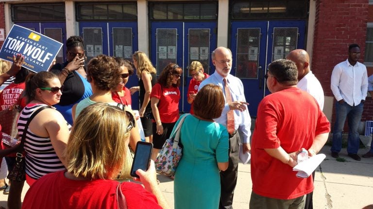 Democratic gubernatorial candidate Tom Wolf is greeted by teachers at the Solis-Cohen Elementary School in Philadelphia Wednesday. (Kevin McCorry/WHYY) 