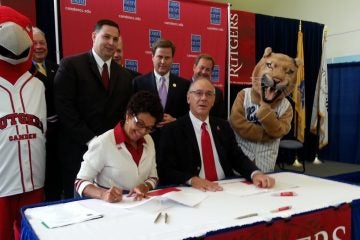  Rutgers Camden Chancellor Phoebe Haddon signs the agreement Monday. (Tom MacDonald/WHYY) 