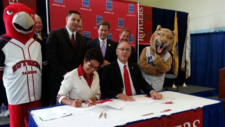  Rutgers Camden Chancellor Phoebe Haddon signs the agreement Monday. (Tom MacDonald/WHYY) 