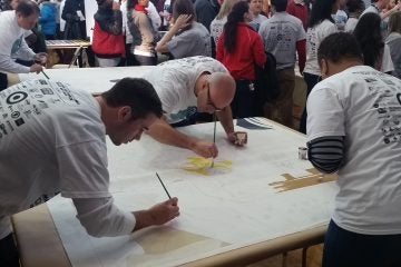  Volunteers work on a mural at Girard College in Philadelphia (Tom MacDonald/WHYY) 