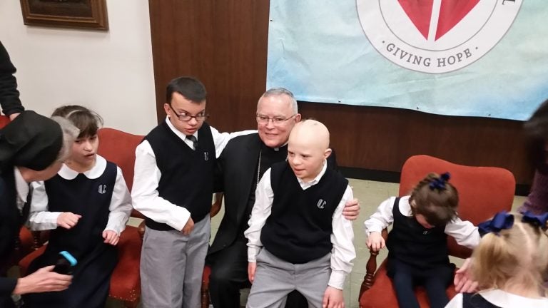  Philadelphia Archbishop Charles Chaput and special-needs children at Catholic Charities announcement. (Tom MacDonald/WHYY) 