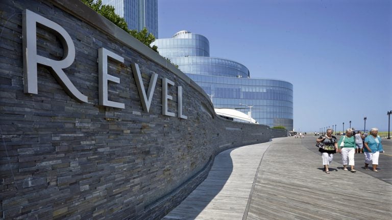  Casino workers and customers walk out of The Revel Hotel Casino together early in the morning Tuesday, Sept. 2, 2014. (AP Photo/Mel Evans) 