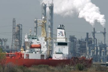  2008 file photo of an oil tanker is docked in Linden, N.J., with the Bayway refinery in background. (AP Photo/Mike Derer, file) 