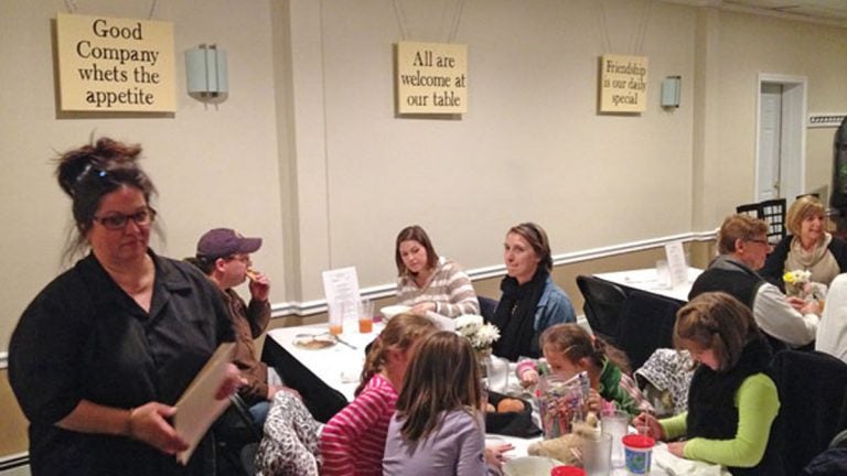  Gigi Liaguno-Dorr waits tables at her weekly community kitchen. 