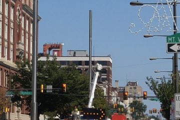  Lighting fixtures go up along North Board Street. (Tom MacDonald/WHYY) 