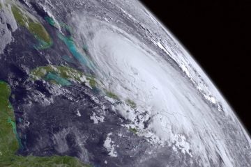  This Tuesday, July 1, 2014, satellite image released by the National Oceanic and Atmospheric Administration shows the center of Tropical Storm Arthur off the east coast of Florida. With the July Fourth weekend on the horizon, the Atlantic hurricane season's first named storm plodded off Florida's coast early Wednesday, though Tropical Storm Arthur wasn't yet spooking too many in the storm's potential path. (NOAA/AP Photo) 