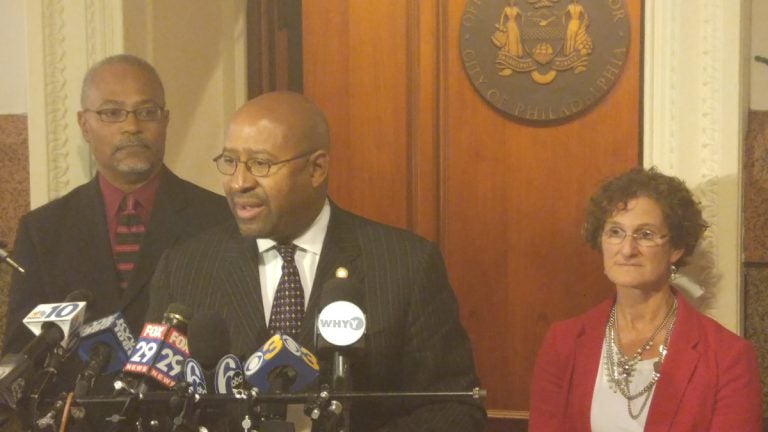  Philadelphia Mayor Michael Nutter, center, and Inspector General Amy Kurland outline the probe into whether the city's Department of Licenses & Inspections is doing its job. (Tom MacDonald/WHYY) 