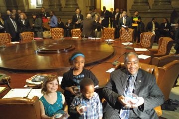 20151029_095745 Philadelphia students brought cupcakes to the Thursday meeting of City Council in thanks for a $25 million infusion to the struggling school district. Seated with some of the children, Councilman Wilson Goode Jr.is all smiles. (Tom MacDonald/WHYY)