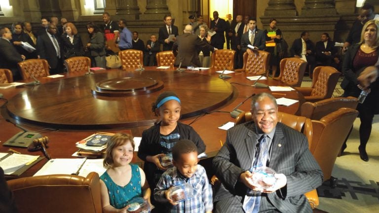  Philadelphia students brought cupcakes to the Thursday meeting of City Council in thanks for a $25 million infusion to the struggling school district. Seated with some of the children, Councilman Wilson Goode Jr.is all smiles. (Tom MacDonald/WHYY) 