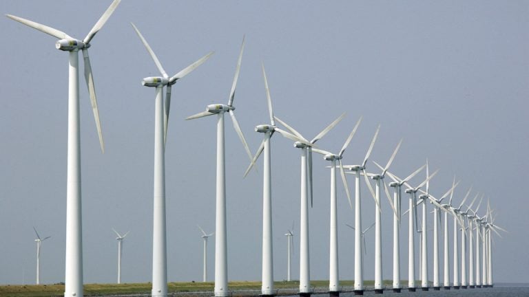 In this July 27, 2006 file photo, wind turbines stand clustered offshore in Dronten, the Netherlands. (AP Photo/ Peter Dejong, File) 