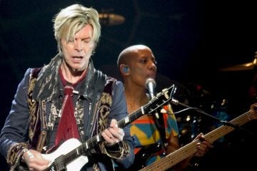  Rock vocalist David Bowie, left, performs at the Fleet Center in Boston, Tuesday, March 30, 2004. (AP Photo/Robert E. Klein) 