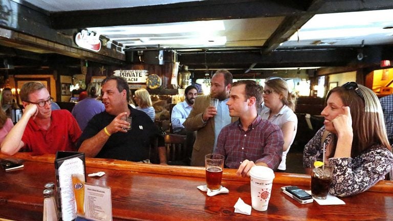  New Jersey Gov. Chris Christie meets with reporters from the New Jersey press corps for annual, off-the-record summer drinks at the Jersey Shore in 2014. Author Matt Katz is in the red shirt.(Tim Larsen/Governor's Office) 