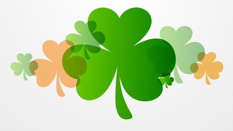 Happy St. Patrick's Day celebration background with clover leaves.