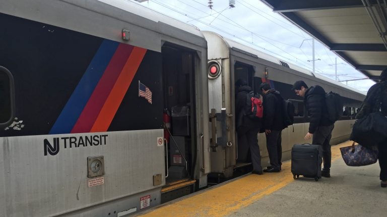 Commuters board the northbound train to NYC from Princeton Junction Station. (Alan Tu/WHYY)