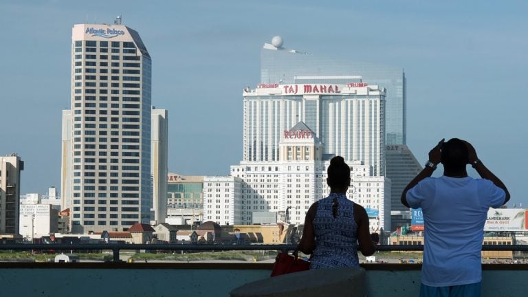 20160703-taj-strike-day-3-1200 A couple looks at the Atlantic City skyline towards the Taj Mahal casino. (Alan Tu/WHYY)