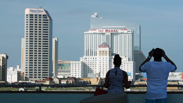 A couple looks at the Atlantic City skyline towards the Taj Mahal casino. (Alan Tu/WHYY)