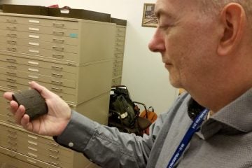 That's not a Blackberry. Philip Jones at the Penn Museum holds a 5000 year old cunieform tablet