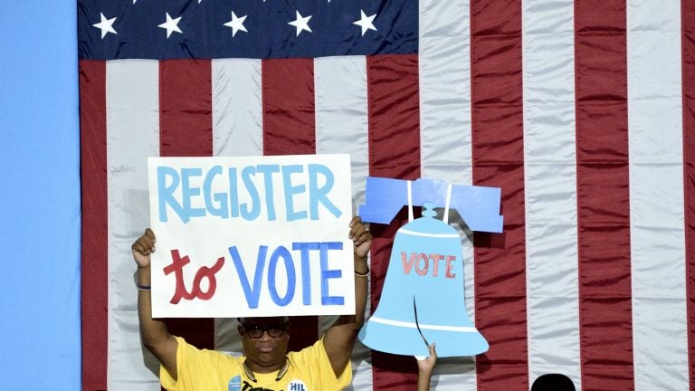 Participants carry signs at a voter registration event in West Philadelphia in August. (Bastiaan Slabbers for NewsWorks)