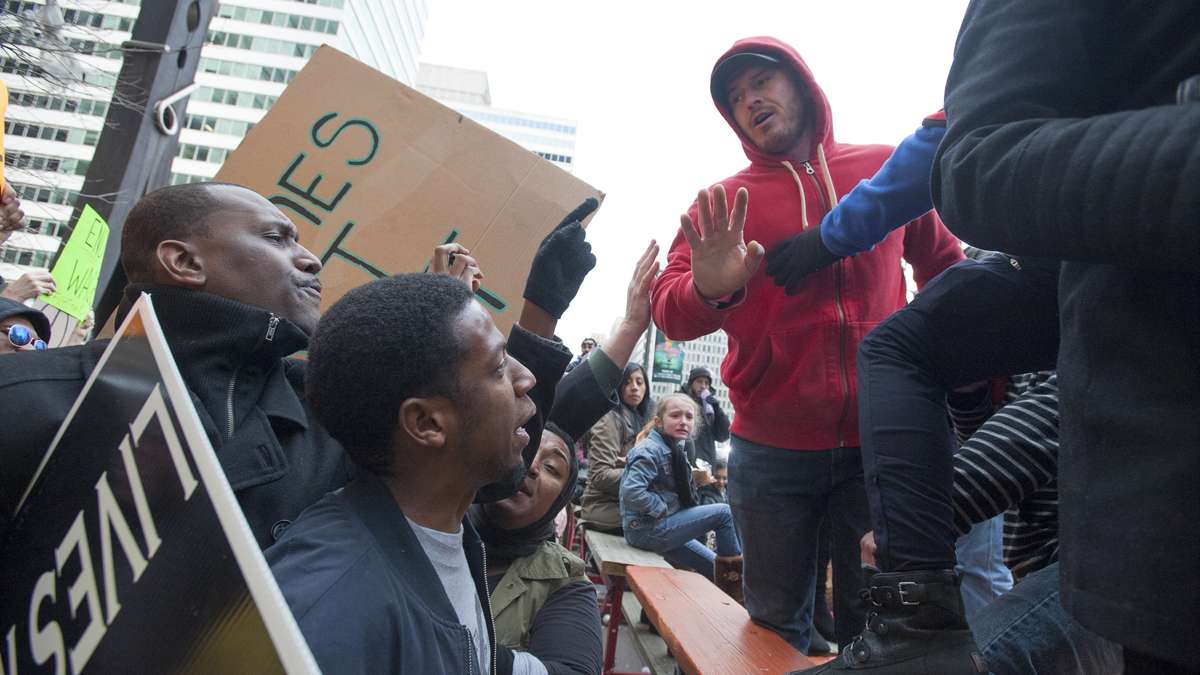  An unidentified spectator, right intervenes to diffuse a confrontation between Black Lives Matter protesters and several Mummers spectators. (Jonathan Wilson/for NewsWorks) 