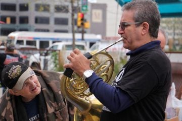 Alan Brown takes a close look at the instrument played by Jeffrey Kirschen, one of a quartet of horn players from the Philadelphia Orchestra. (Emma Lee/WHYY)