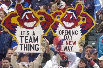  In this April 8, 2002 photo, fans hold up Chief Wahoo logo signs as they celebrate the Cleveland Indians' opening win over the Minnesota Twins in Cleveland, Ohio. (Tony Dejak/AP Photo, file) 