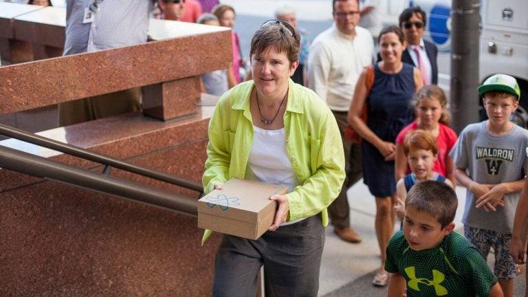  Fired teacher Margie Winters delivers petitions signed by more than 20,000 supporters who are seeking to have her reinstated at Waldron Mercy Academy. Winters, who was let go because of her same-sex marriage, handed the pleas to a Archdiocese of Philadelphia security guard.(Brad Larrison/for NewsWorks) 