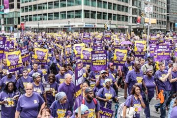 32BJ SEIO janitors marched through Center City Wednesday to demand fair wages. (Kimberly Paynter/WHYY)