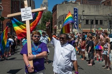 Austin Ellis (left) and the Rev. Jeffrey Jordan of Whosoever Community Church carry a memorial to the Pulse night club victims at Philly Pride parade on Sunday. (Avi Wolfman-Arent