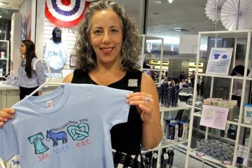 Bucks County artist LisaBeth Weber shows off one of her designs for official Democratic National Convention merchandise. (Emma Lee/WHYY)