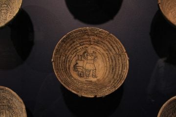 Incantation bowls were decorated with images of bound demons enveloped by spiraling incantations. They were placed upside down at the entrances of Mesopotamian homes for protection. (Emma Lee/WHYY)