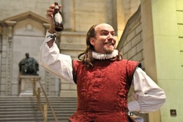 Brian McCann, acting as Shakespeare at the Free Library of Philadelphia, declares Yards Brewing Company's Shakesbeer, an English-Style Session Ale, his favorite drink. (Kimberly Paynter/WHYY)