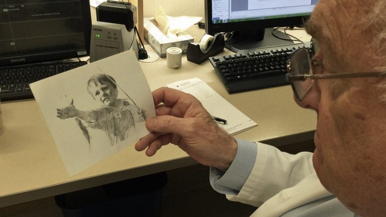 Michael LaCombe holds the card he received from a patient he treated 50 years ago. (Courtesy of Michael LaCombe)
