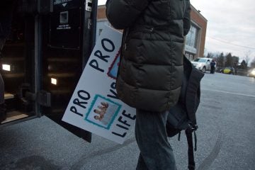 A woman boards a bus at Holy Cross School in Springfield, Pennsylvania, which will carry her to the annual March for Life in Washington, D.C., on Friday, January 27, 2017. (Emily Cohen for NewsWorks)