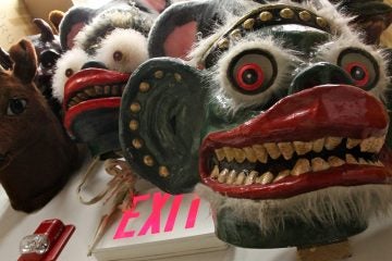 In the showroom, many elaborate masks hang from the walls. (Emma Lee/WHYY)