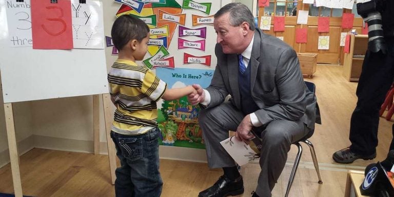 Philadelphia Mayor Jim Kenney shakes hands with a student at Kinder Academy