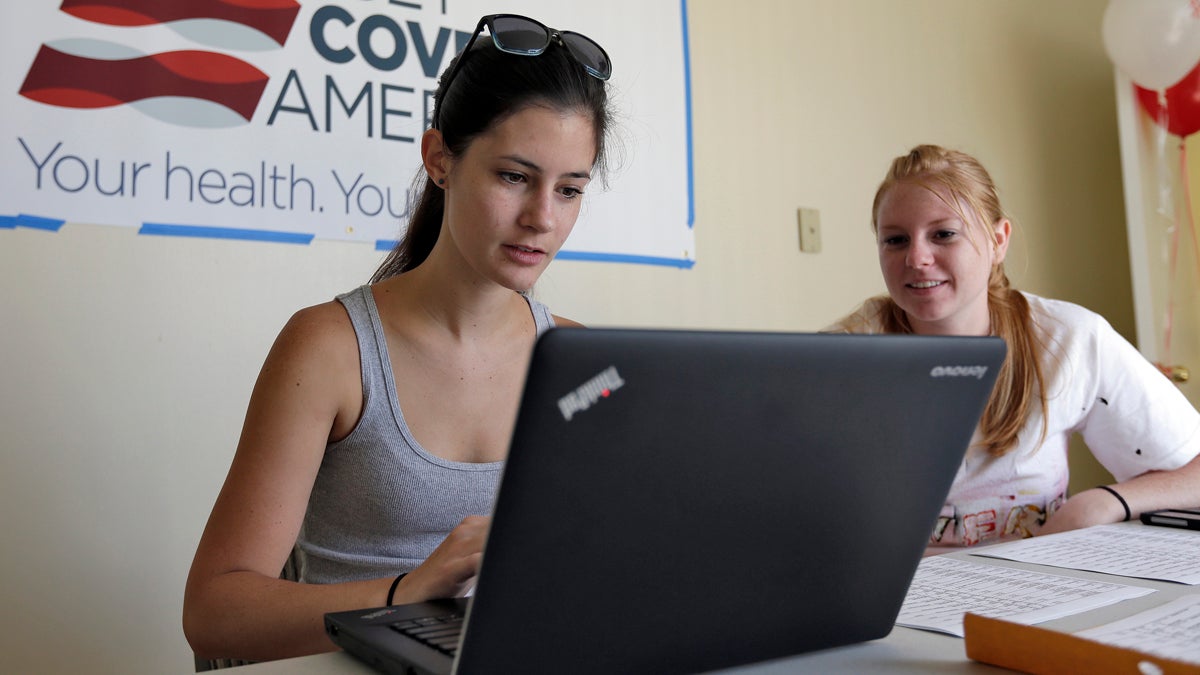  Ashley Hentze, left, of Lakeland, Fla., gets help signing up for the Affordable Care Act from Kristen Nash, a volunteer with Enroll America.  (AP Photo/Chris O'Meara) 